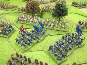 French men at arms attack the central woodland. The infantry move in column to give them the 2-hexes of movement required to make contact.