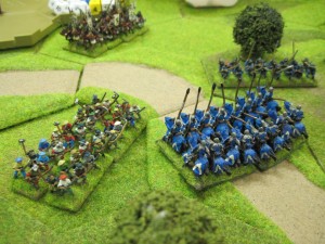 The French knights smash through the peasants and the foot Samurai along the road