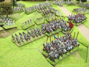 Mounted men at arms charge the Teutonic infantry in the centre.